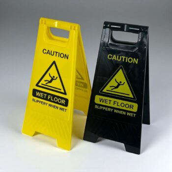 Plastic wet floor signs in safety yellow and black, side by side, A-frame caution signs for cleaning and spill response